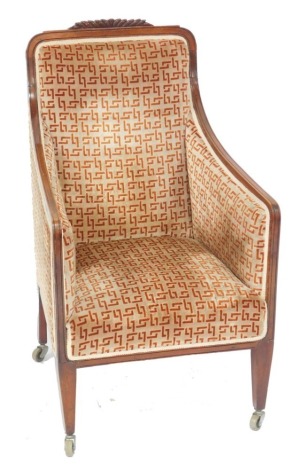 A late Victorian mahogany armchair, with a carved crest rail, upholstered in overstuffed geometric patterned fabric, raised on a tapering square legs, on castors, 57cm wide.