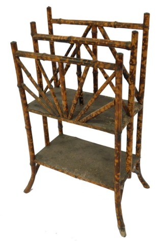 A Victorian aesthetic bamboo newspaper and magazine rack, with a graduated two tier upper section, raised on outswept legs united by an under tier, 26.5cm high, 50cm wide, 31cm deep.