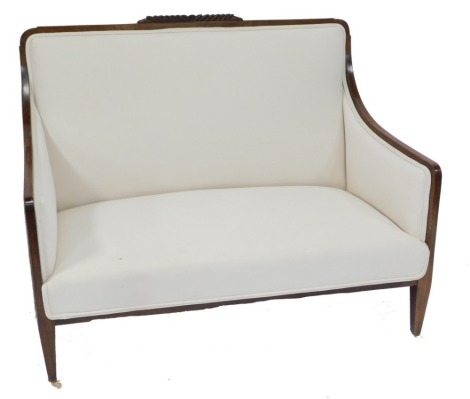 A Victorian mahogany two seater sofa, upholstered in cream overstuffed fabric, raised on tapering square legs, brass capped on castors, 94cm high, 122cm wide, 58cm deep.