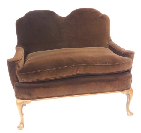 A Georgian style walnut two seater humpback sofa, upholstered in brown draylon, raised on cabriole legs, 94cm high, 116cm wide, 54cm deep.