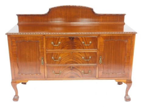 An Edwardian mahogany sideboard, with a carved back over three central drawers flanked by a pair of cupboard doors, one containing a shelf, the other with a cellarette, raised on cabriole legs and ball and claw feet, 118cm high, 152cm wide, 54cm deep.