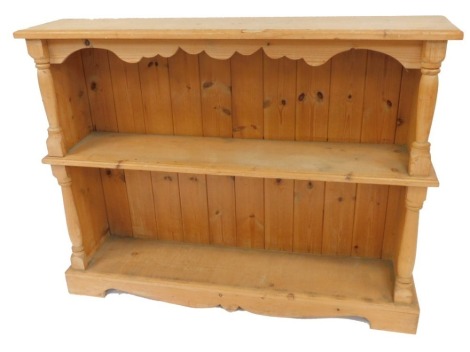 A pine open bookcase, with two shelves, raised on bracket feet, 79cm high, 102cm wide, 22cm deep.