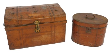 An early 20thC tin hat box, 32cm high, together with a tin trunk, with cast iron carrying handles, and brass lock plate, 58cm wide. (2)