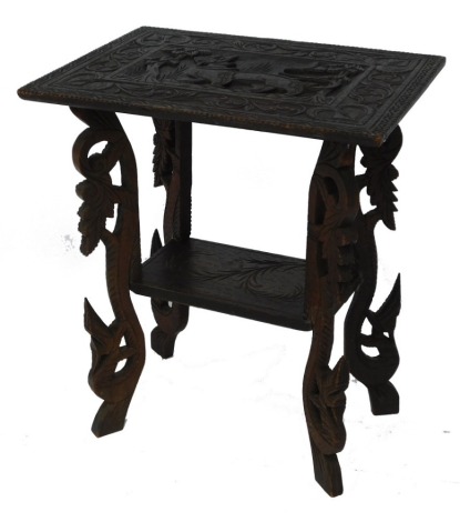 A Far Eastern hardwood occasional table, the top carved with an exotic beast, within a foliate border, raised on leaf carved scrolling legs united by an under tier, 63cm high, 55cm wide, 40cm deep.