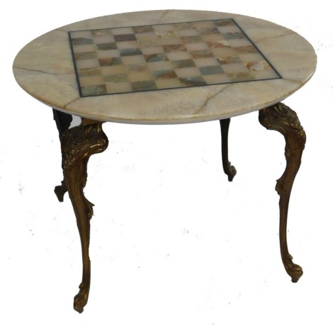 A late 20thC onyx chess board topped circular occasional table, raised on brass cabriole legs, 43cm high, 60cm wide.