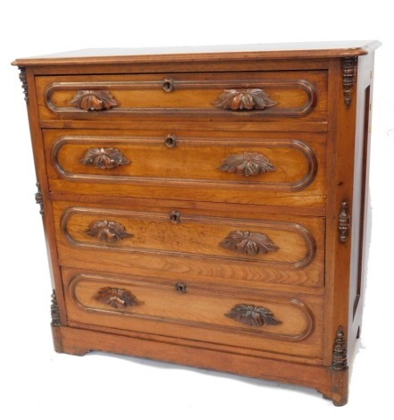 A Victorian oak chest of four long graduated drawers, with fruit and foliate carved cup handles, raised on a plinth base, 99cm high, 102cm wide, 48cm deep.