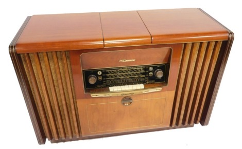 A Grundig mid century mahogany cased radiogram, with 3D sound, 52cm high, 117cm wide, 44cm deep.