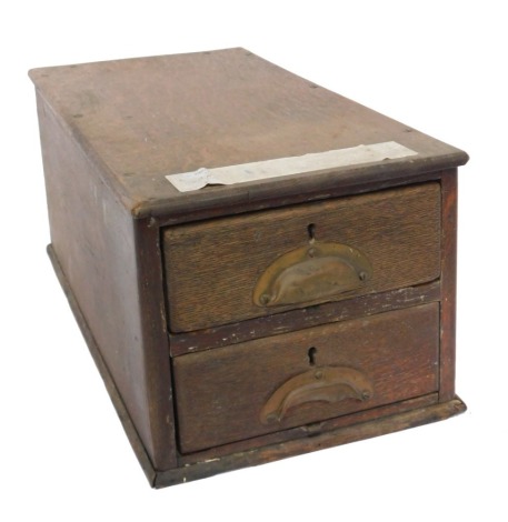 A Victorian oak cash till, having two drawers with copper cup handles, 23cm high, 27cm wide, 54cm deep.