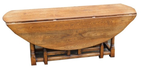 An oak wake type drop leaf dining table, raised on turned legs united by a box stretcher, 74cm high, 197cm wide, 62cm deep, 150cm extended.