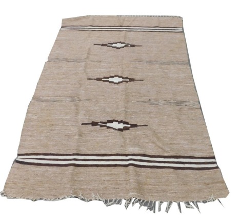 An Afghan Kilim rug, decorated with three geometric motifs and brown and white stripe bands against a woven oatmeal field, 238cm x 156cm.