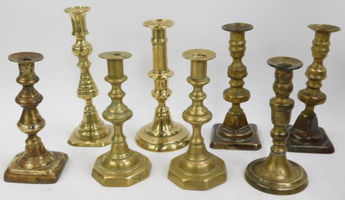 A selection of brass candlesticks, mainly singles but one pair. (a quantity)