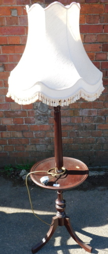 A mahogany standard lamp, with wine table base and shade.