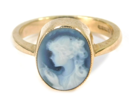 A 9ct gold blue agate cameo dress ring, with figure looking left, in a rub over setting on plain design band, size N 1/2, 3.4g all.