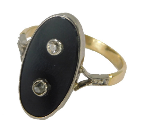 A Victorian oval dress ring, the central oval onyx in a rub over white gold setting, two central diamonds and diamond set shoulders on a yellow metal band stamped 18ct, size S 1/2, 4.1g all.