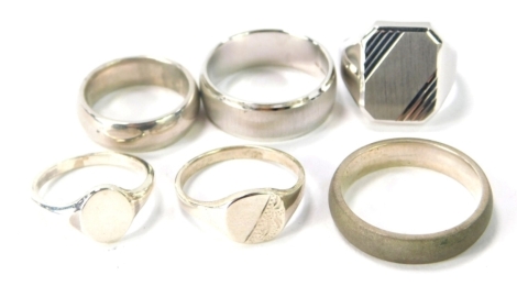 Six silver dress rings, comprising a gentleman's dress ring, with rectangular panel, ring size R½, a silver 5mm wedding band, ring size W, a silver 5mm brushed wedding band, ring size V½, a silver plain wedding band, ring size N, silver oval signet ring, 