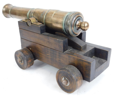 A 19thC brass table cannon, numbered 5, on a stepped wooden base, 23cm high, 31cm wide. - 4