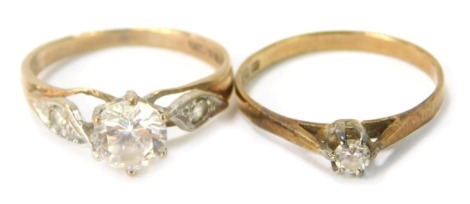 Two 9ct gold dress rings, each solitaire set with cz stone, one with cz set shoulders, 2.9g all in. (2)