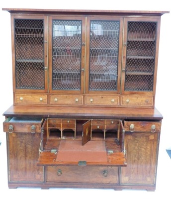 A Regency mahogany secretaire cabinet bookcase, with rosewood cross banding and ebony inlay, the upper part having a moulded cornice over four brass grill doors and drawers, the base with a secretaire drawer over two further drawers, enclosed by cupboards - 2