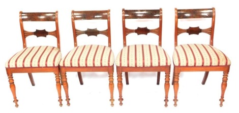 A set of four William IV mahogany dining chairs, with bar backs, Regency stripe seats, and turned legs.