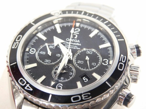 An Omega Seamaster Co-Axial Automatic chronometer chronograph, with stainless steel bracelet, articulated bezel, 3cm diameter black dial, with three further dials, baton and Arabic numerals, and arrow pointers, the strap marked Professional Planet Ocean w