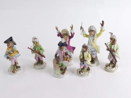 A comprehensive continental harlequin porcelain monkey band, to include conductor, in yellow jacket with arms raised, 21cm high, French horn player, violinist, further conductor and other various pieces, pottery monkey band drummer, KISTER marks.