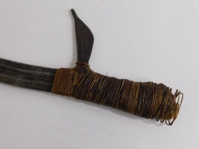 An African Kpinga throwing knife, with shaped elaborate blade and turned handle, 55cm high. - 2