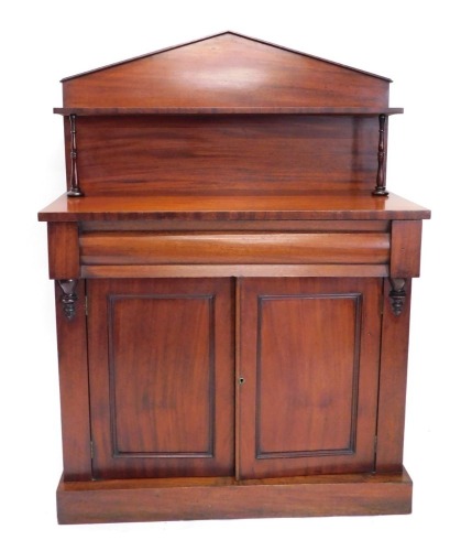 A Victorian mahogany chiffonier, with fixed top above open shelf, on turned supports, the subsection with cushion drawer above double cupboards, on a block base, 149cm high, 98cm wide, 42cm deep.