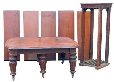 A fine Victorian mahogany extending dining table, with moulded top, on six heavy jewel carved and fluted legs on castors, 146cm wide, 168cm min plus a leaf cabinet with five of the six leaves, each being 43cm giving a total length of approximately 412cm.