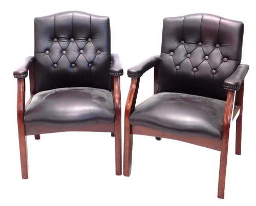 A pair of modern leather button back chairs, with serpentine seats, on square legs, 89cm high.