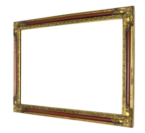 A rectangular wall mirror, with raised metal spandrels and bevel glass, 75cm high, 106cm wide, 4cm deep.