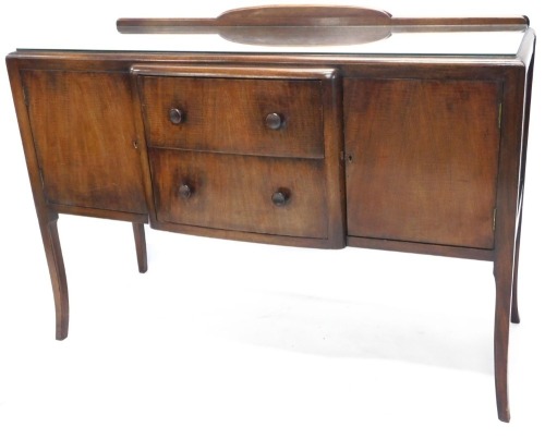 A 1950's sideboard, with two central drawers, on splayed legs.