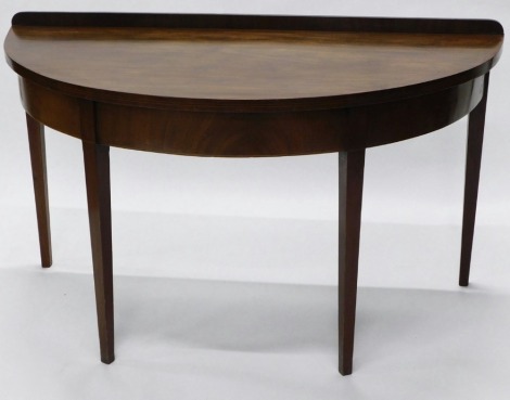 A 19thC flame mahogany demi lune side table, on square taper legs, 124cm wide.