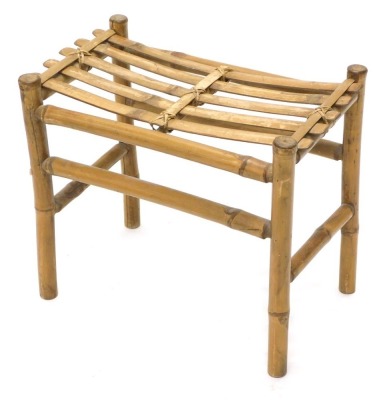 A bamboo style luggage rack, with slatted top on turned legs joined by a horizontal front legs, 49cm high, 46cm wide, 32cm deep.