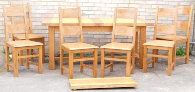 A light oak dining room suite, comprising extending table, with rectangular top on block feet, joined by a heavy H stretcher and additional leaf, when closed 80cm high, 180cm wide, 91cm deep with six chairs.