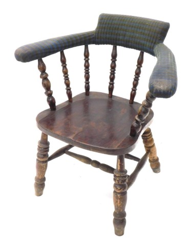 A mid 20thC railway style smoker's bow chair, upholstered in blue and yellow striped British Rail style material, with a shaped seat, on turned legs joined by a double H stretcher, 85cm high.