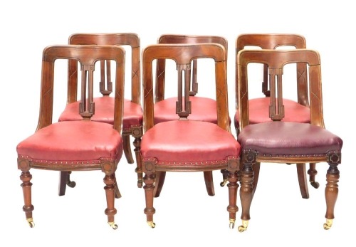 A set of four Victorian mahogany spoon back dining chairs, each with a solid splat and red upholstered seat and two similar. (6)