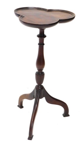 A 20thC mahogany occasional table, the clover leaf top on baluster stem, terminating in triple down swept legs with compressed rectangular feet, 57cm high.