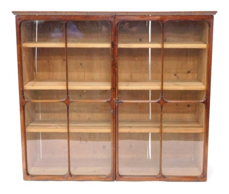 A late 19thC mahogany framed confectionary or shop cabinet, with panelled doors and pine shelves, 125cm high, 141cm wide, 45cm deep.