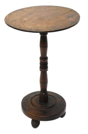 A 19thC occasional table, the plain circular top on inverted turned stem, terminating in a platform base with orb feet, 70cm high, 45cm diameter.