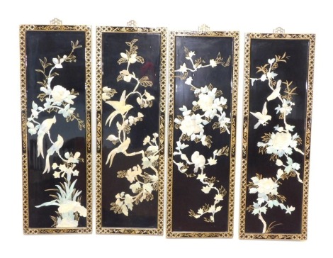 A set of four modern Japanese lacquer panels, each raised with mother of pearl finish flowers, with gilt stencil floral borders and elaborate metal hangers, 94cm high, 31cm wide, 3cm deep. (4)