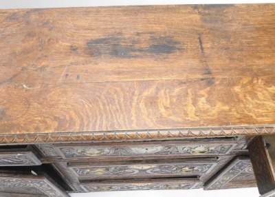 A Victorian oak sideboard, with part moulded top, raised above an arrangement of three central drawers flanked by two drawers and cupboards, each heavily carved with flowers and scrolls, on block stiles, 81cm high, 162cm wide, 46cm deep. - 3