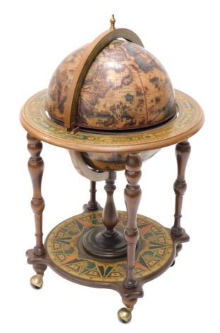 A modern globe cocktail cabinet, with transfer printed body, on baluster central stem, with turned supports terminating in castors, with part fitted interior, 98cm high.