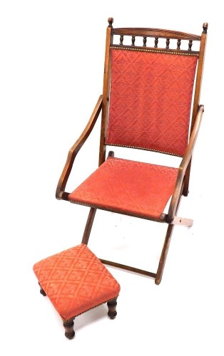 An X framed Glastonbury style chair, with mitre upholstered back and seat, and similar designed footstool, 32cm wide.