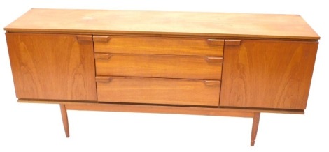 A vintage G-Plan style teak sideboard, with three drawers flanked by cupboards, on turned legs, 80cm high, 182cm wide, 47cm deep.