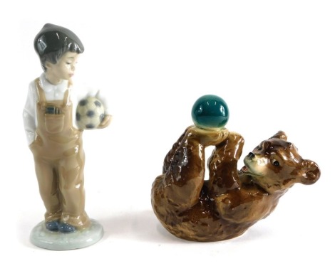 A Goebel Hummel bear and ball figure, marked beneath, 12cm high, and a Nao figure of a child holding football.