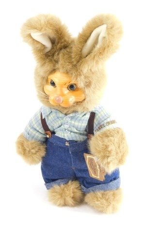 A Robert Raikes original rabbit teddy bear wearing dungarees, marked Everyone Loves to Get Applause, signed under foot, 33cm high.