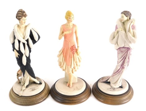 Various Capodimonte figures of ladies, one in flowing purple dress on wooden stand, signed, 27cm high, and two others. (3)