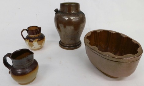 Various stoneware, a two coloured Dwight style pottery jug, with ribbed top, beak spout and shaped handle, a Golden Jubilee Doulton Lambeth Queen Victoria Coronation jug, jelly mould, and a further stoneware vase. (4)