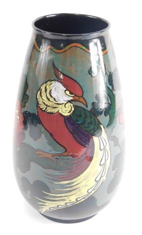 A 20thC Decoro lustre pottery vase, decorated with bird and flowers predominantly in purple, green, and yellow, on circular foot, printed marks beneath, 32cm high.