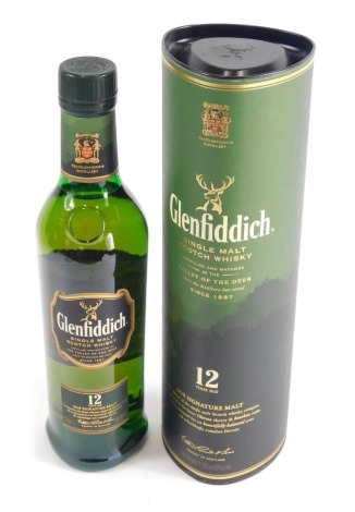 A bottle of Glenfiddich twelve year old signature malt, in cardboard tube.